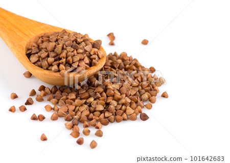 Uncooked buckwheat on wooden spoon Uncooked buckwheat on wooden spoon 101642683