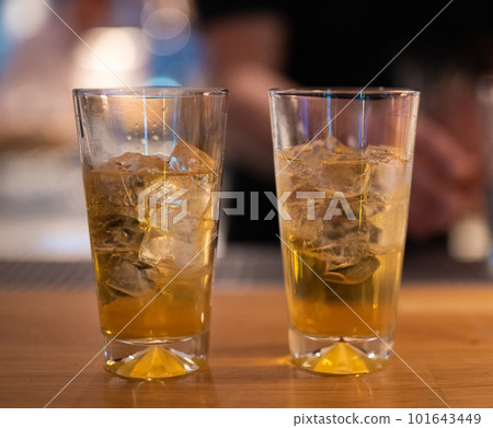 beautiful and delicious alcoholic cocktails prepared at the bar by the bartender. 101643449