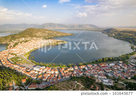 Landscape of countryside town, village and lake of Orestiada in Kastoria during summer sunny day over a mountain peak in Greece. Aerial, drone, top view. Panorama Landscape of countryside town, village and lake of Orestiada in Kastoria during summer sunny day over a mountain peak in Greece. Aerial, drone, top view. Panorama 101643677