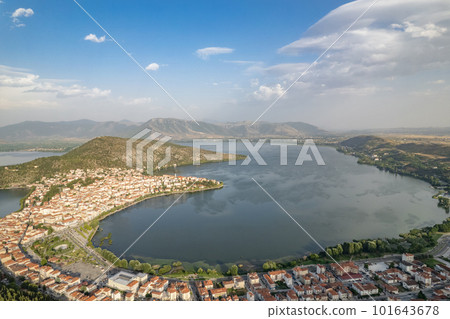 Landscape of countryside town, village and lake of Orestiada in Kastoria during summer sunny day over a mountain peak in Greece. Aerial, drone, top view. Panorama Landscape of countryside town, village and lake of Orestiada in Kastoria during summer sunny day over a mountain peak in Greece. Aerial, drone, top view. Panorama 101643678