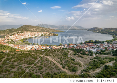 Landscape of countryside town, village and lake of Orestiada in Kastoria during summer sunny day over a mountain peak in Greece. Aerial, drone, top view. Panorama Landscape of countryside town, village and lake of Orestiada in Kastoria during summer sunny day over a mountain peak in Greece. Aerial, drone, top view. Panorama 101643681