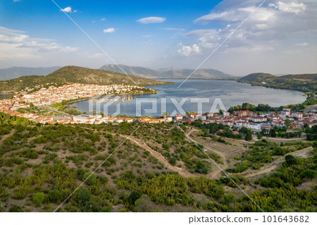Landscape of countryside town, village and lake of Orestiada in Kastoria during summer sunny day over a mountain peak in Greece. Aerial, drone, top view. Panorama Landscape of countryside town, village and lake of Orestiada in Kastoria during summer sunny day over a mountain peak in Greece. Aerial, drone, top view. Panorama 101643682