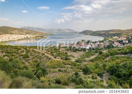 Landscape of countryside town, village and lake of Orestiada in Kastoria during summer sunny day over a mountain peak in Greece. Aerial, drone, top view. Panorama 101643683