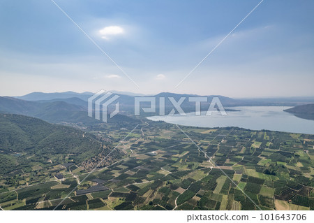 Landscape of countryside town, village and lake of Orestiada in Kastoria during summer sunny day over a mountain peak in Greece. Aerial, drone, top view. Panorama Landscape of countryside town, village and lake of Orestiada in Kastoria during summer sunny day over a mountain peak in Greece. Aerial, drone, top view. Panorama 101643706