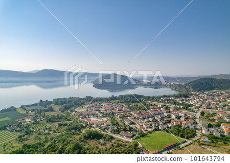 Landscape of countryside town, village and lake of Orestiada in Kastoria during summer sunny day over a mountain peak in Greece. Aerial, drone, top view. Panorama Landscape of countryside town, village and lake of Orestiada in Kastoria during summer sunny day over a mountain peak in Greece. Aerial, drone, top view. Panorama 101643794