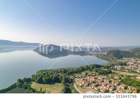 Landscape of countryside town, village and lake of Orestiada in Kastoria during summer sunny day over a mountain peak in Greece. Aerial, drone, top view. Panorama Landscape of countryside town, village and lake of Orestiada in Kastoria during summer sunny day over a mountain peak in Greece. Aerial, drone, top view. Panorama 101643796