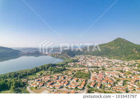 Landscape of countryside town, village and lake of Orestiada in Kastoria during summer sunny day over a mountain peak in Greece. Aerial, drone, top view. Panorama 101643797