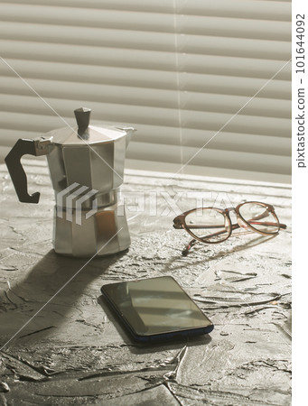 Breakfast with coffee moka pot and smartphone and eyeglasses. Morning meal and breakfast concept. 101644092