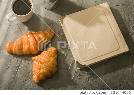 Still life for pleasant morning coffee turk cup and croissants with book on table. Lunch break concept or start the morning Still life for pleasant morning coffee turk cup and croissants with book on table. Lunch break concept or start the morning 101644096
