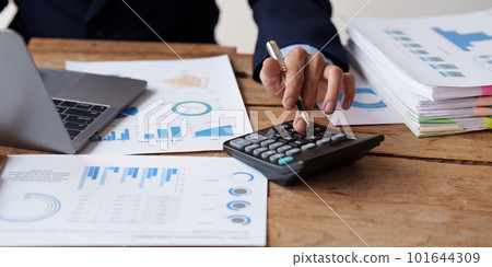 Close up Accountant man working with calculator and do document, tax, exchange, accounting and Financial advisor concept Close up Accountant man working with calculator and do document, tax, exchange, accounting and Financial advisor concept 101644309
