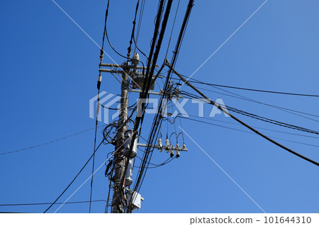 Telephone pole looking up against the blue sky Telephone pole looking up against the blue sky 101644310