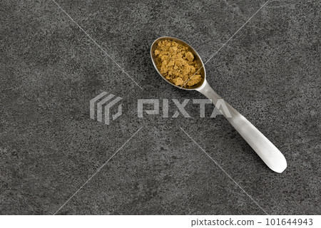 Yellow curry spice in a measuring spoon Yellow curry spice in a measuring spoon 101644943