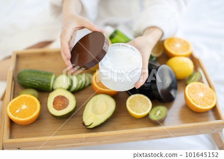 Female opening facial cream on skincare remedies background 101645152