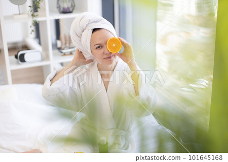 Adult using orange fruit for beauty care at home Adult using orange fruit for beauty care at home 101645168
