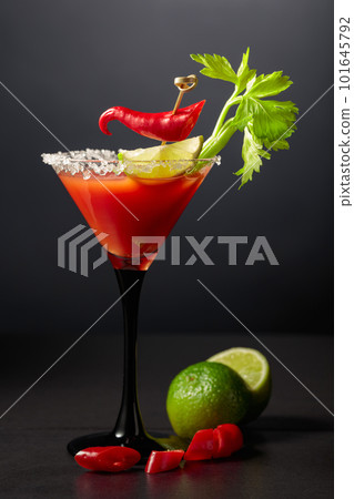 Bloody Mary cocktail with celery, lime, and red pepper. Bloody Mary cocktail with celery, lime, and red pepper. 101645792