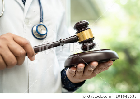 Doctor holding judge gavel, forensic medicine, medical law and crime justice concept. 101646533