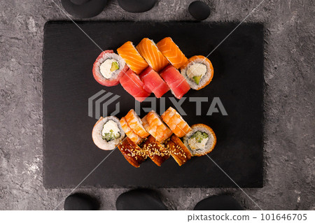 Sushi rolls set on dark background. Japanese and asian food concept top view Sushi rolls set on dark background. Japanese and asian food concept top view 101646705