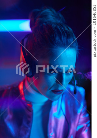 pensive trendy 40 years old woman with headset 101646853