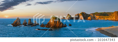 Atlantic ocean coastline landscape in red sunset sunrays. Beautiful Gueirua beach with sharp islets, Asturias, Spain. 101647343