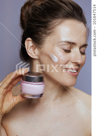 happy woman with cosmetic cream jar happy woman with cosmetic cream jar 101647514