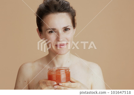 Portrait of happy young 40 years old woman with face scrub 101647518