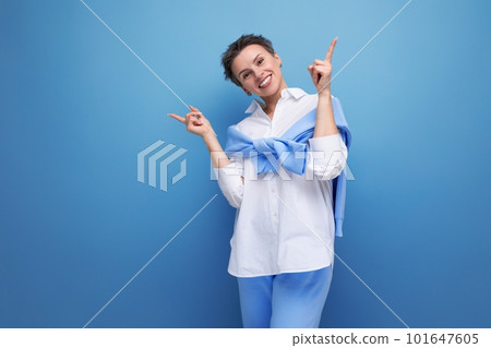 energetic fashionable dark-haired woman in a cool look with a genius proposal points her finger energetic fashionable dark-haired woman in a cool look with a genius proposal points her finger 101647605