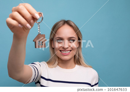 horizontal photo of a happy young woman who bought an apartment in a mortgage on a blue isolated horizontal photo of a happy young woman who bought an apartment in a mortgage on a blue isolated 101647633