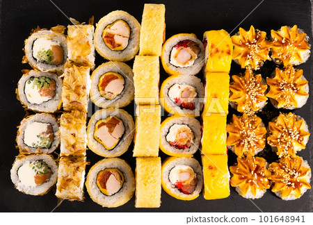 Sushi rolls set on dark background. Japanese and asian food concept 101648941