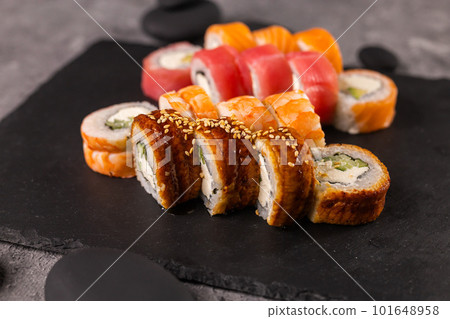 Sushi rolls set on dark background. Japanese and asian food concept Sushi rolls set on dark background. Japanese and asian food concept 101648958