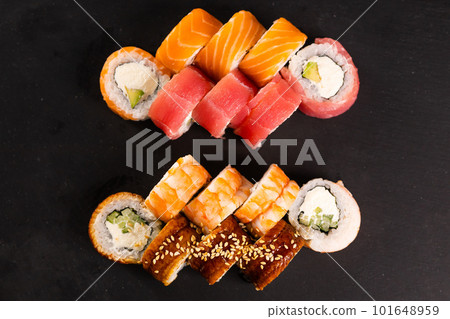 Sushi rolls set on dark background. Japanese and asian food concept top view 101648959