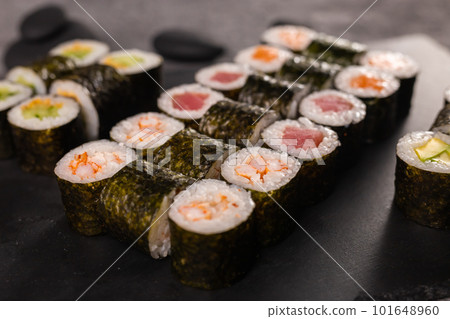Sushi rolls set on dark background. Japanese and asian food concept Sushi rolls set on dark background. Japanese and asian food concept 101648960