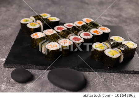 Sushi rolls set on dark background. Japanese and asian food concept Sushi rolls set on dark background. Japanese and asian food concept 101648962