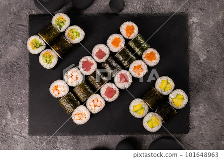 Sushi rolls set on dark background. Japanese and asian food concept Sushi rolls set on dark background. Japanese and asian food concept 101648963