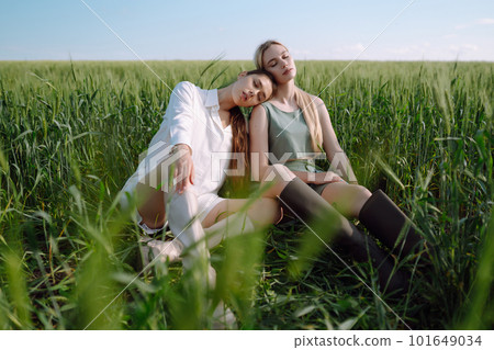Two Beautiful woman in the green field. Nature, vacation, relax and lifestyle. Summer landscape. Two Beautiful woman in the green field. Nature, vacation, relax and lifestyle. Summer landscape. 101649034
