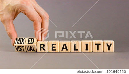 Mixed or virtual reality symbol. Concept words Mixed reality Virtual reality on wooden cubes. Beautiful grey background. Businessman hand. Business mixed or virtual reality concept. Copy space. 101649530