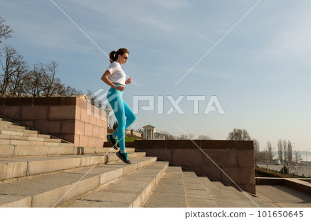 Young woman jogging on city streets 101650645