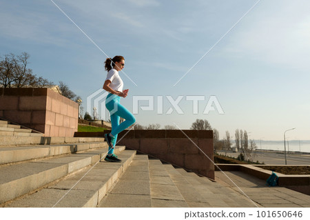 Young woman running on city streets 101650646