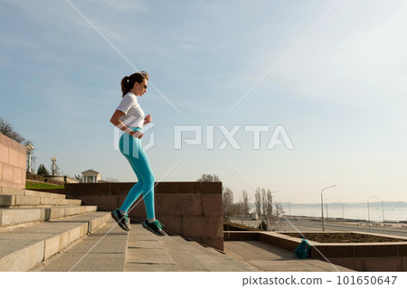 Young woman jogging on city streets Young woman jogging on city streets 101650647
