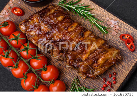 Delicious grilled pork ribs with sauce, spices and herbs 101650735
