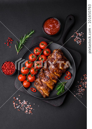 Delicious grilled pork ribs with sauce, spices and herbs Delicious grilled pork ribs with sauce, spices and herbs 101650763