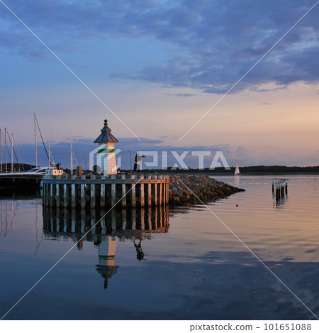 Small lighthouse and sailing boats at sunset in Ebeltoft. Small lighthouse and sailing boats at sunset in Ebeltoft. 101651088