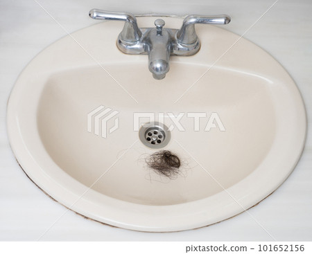 Messy hair clump in sink Messy hair clump in sink 101652156