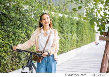 Happy female smiling walk down the street with her bike on city road, ECO environment, Lifestyle Asian young woman walking alongside with bicycle on summer in countryside outdoor, healthy travel Happy female smiling walk down the street with her bike on city road, ECO environment, Lifestyle Asian young woman walking alongside with bicycle on summer in countryside outdoor, healthy travel 101654302