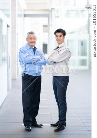 Two men in work clothes, arms folded Two men in work clothes, arms folded 101655013