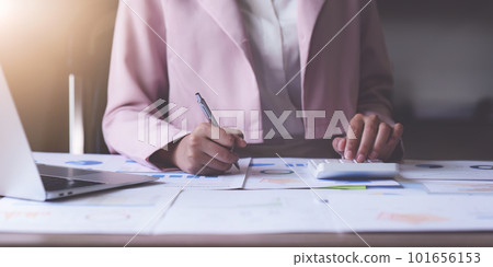 Asian Business person makes analysis and research financial report at office, analyzes profits. Accountant checks status of financial 101656153