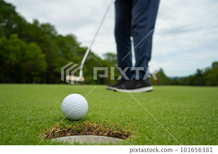 Blurred golfer playing golf in the evening golf course, on sun set evening time. Blurred golfer playing golf in the evening golf course, on sun set evening time. 101656381