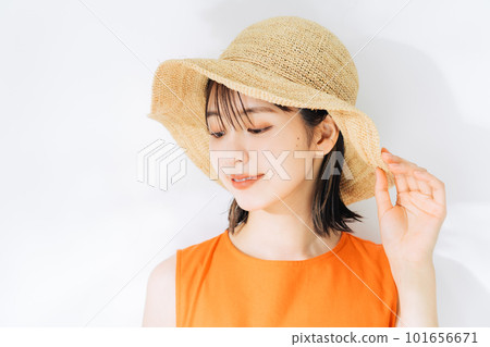 young woman wearing a straw hat young woman wearing a straw hat 101656671
