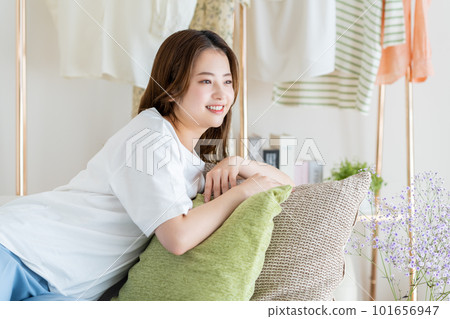 Young woman relaxing in the living room Young woman relaxing in the living room 101656947