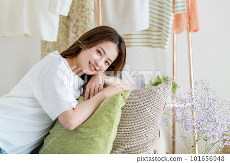 Young woman relaxing in the living room Young woman relaxing in the living room 101656948
