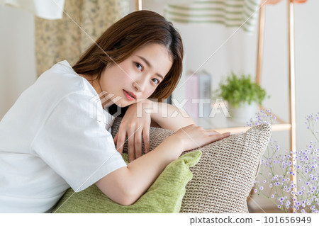 Young woman relaxing in the living room Young woman relaxing in the living room 101656949